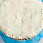 Overhead shot of frosted cake on a blue cake stand