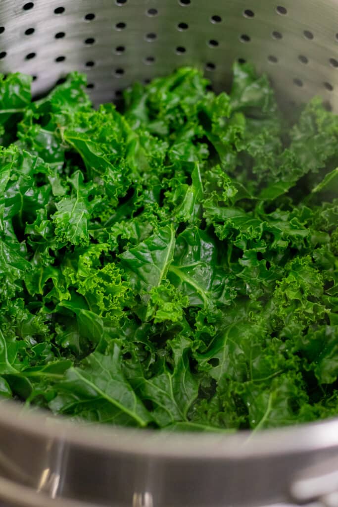 Fresh green kale in a steamer pot