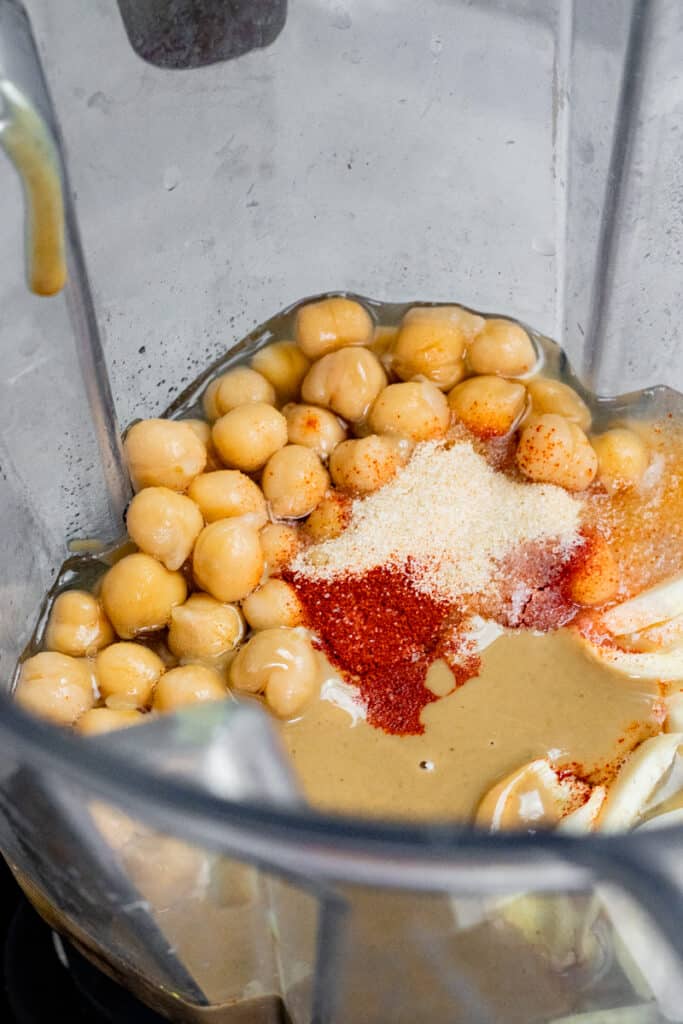 ingredients for hummus added to a large blender