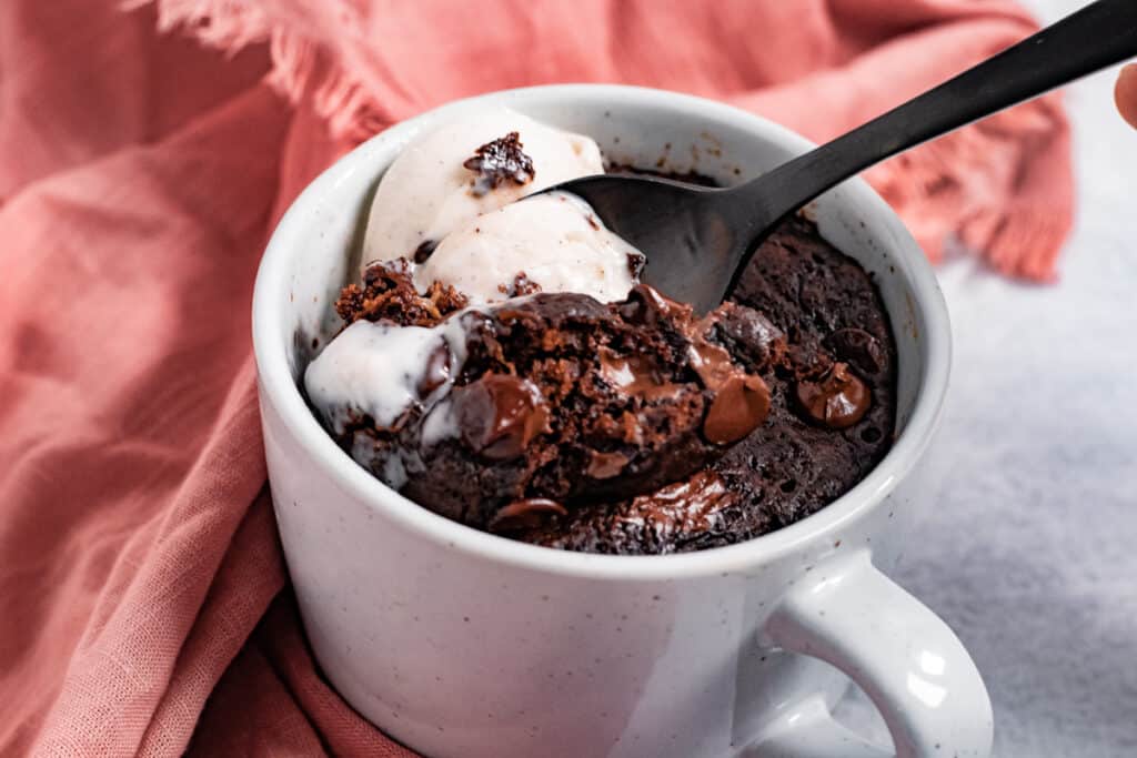 Spoon dipping into mug brownie