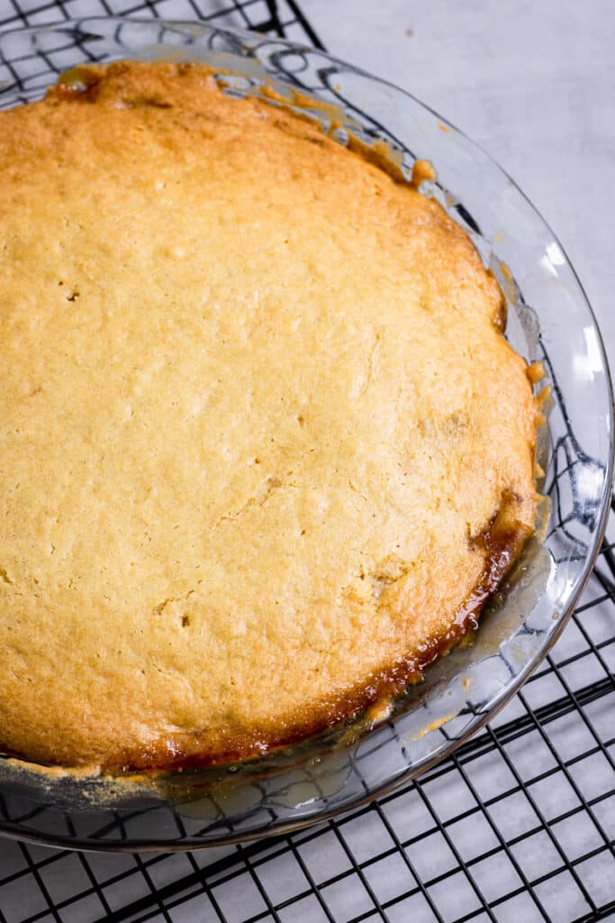 Letting the cake cool on a baking rack before removing