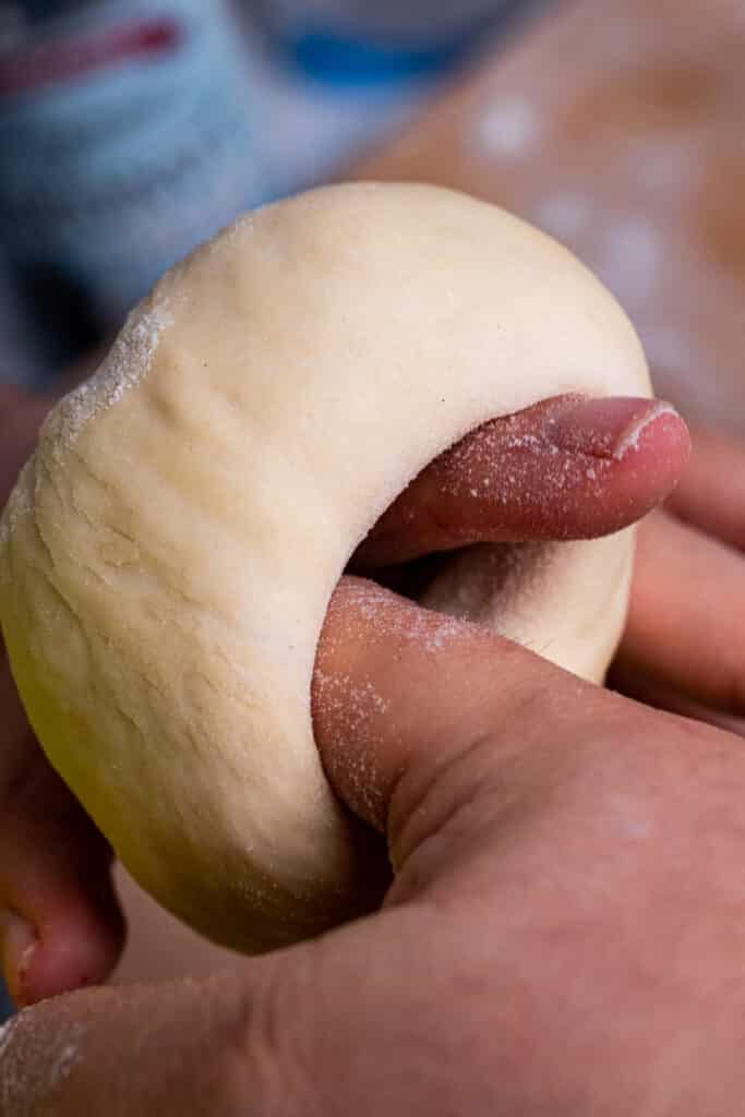 Forming dough into bagel rings