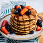 Plant-based pancakes covered in fruit and date syrup