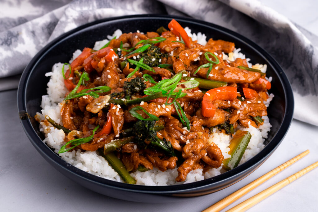 Bowl of vegan tsos with chop sticks