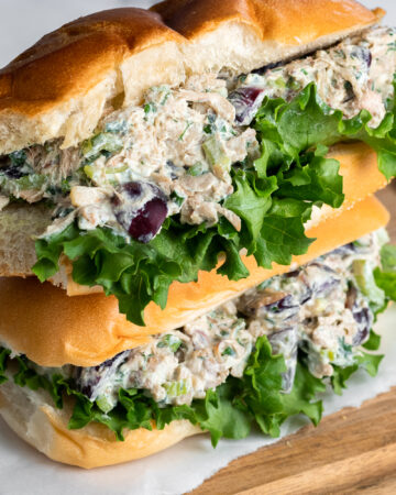 Horizontal photo of two vegan chicken salad sandwiches stacked up