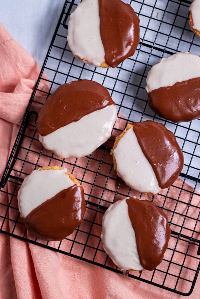 Half moon cookies on a cooling rack