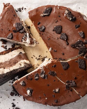A cut ice cream cake with chocolate and vanilla layers