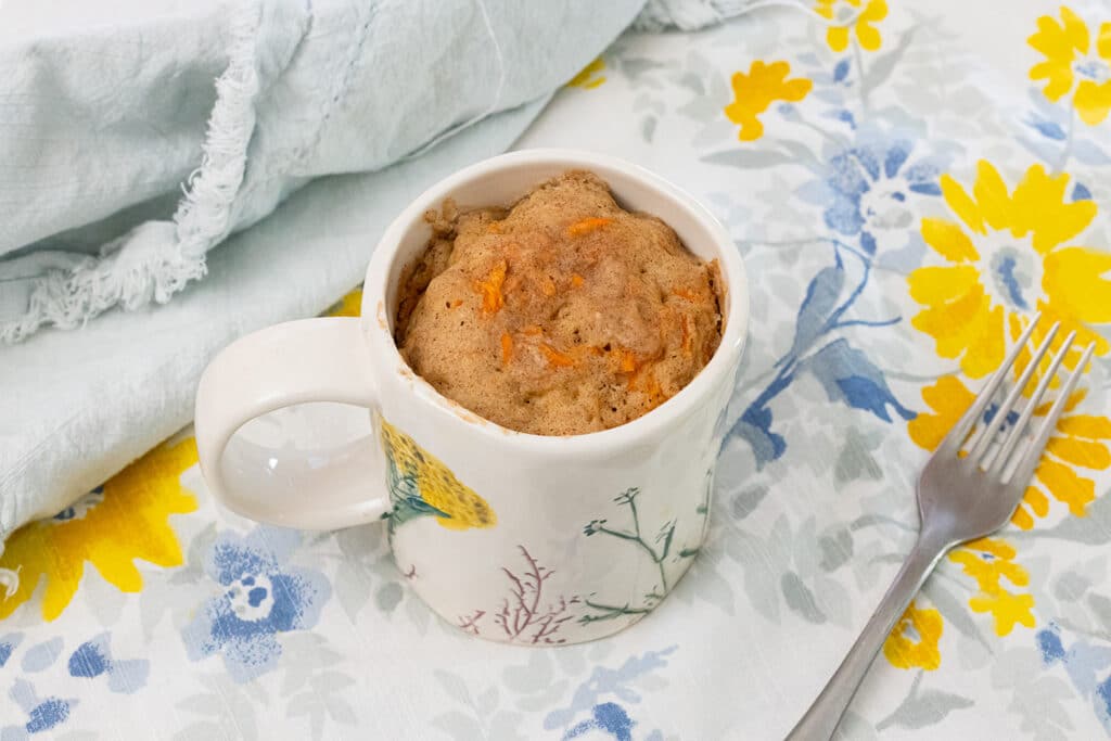 Carrot cake mug cake on a table.
