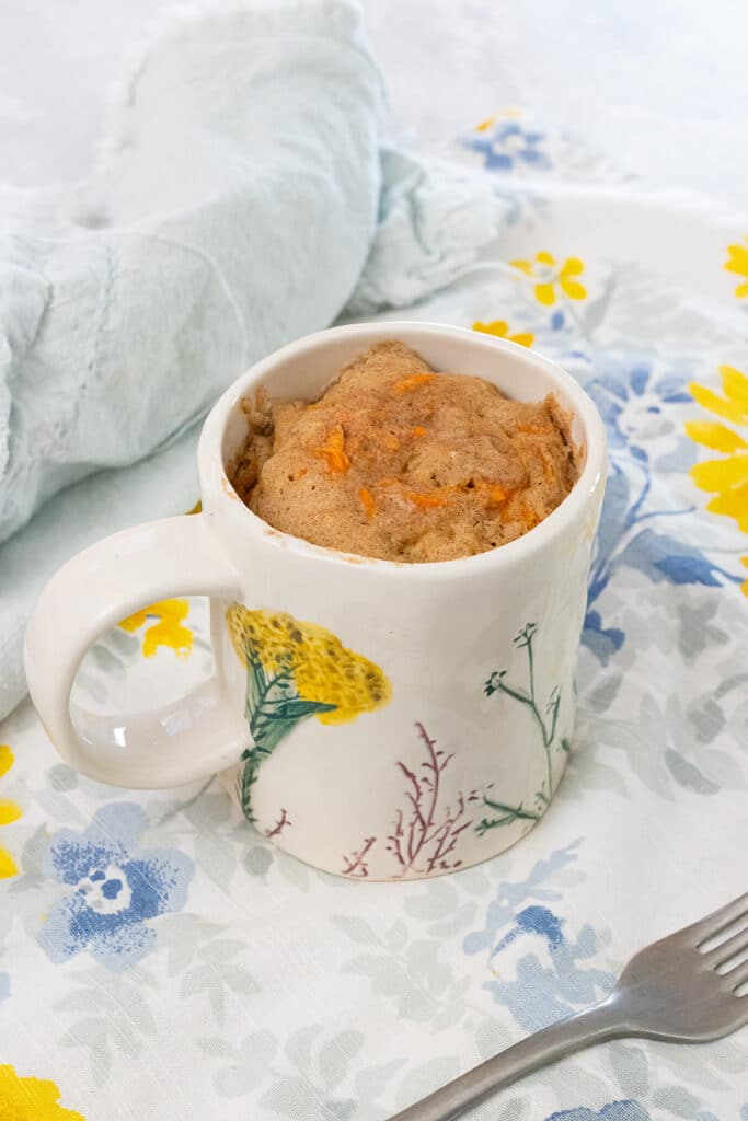 Carrot cake mug cake on a table.