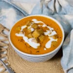 Carrot and Red Pepper Soup in a bowl with crispy tofu.